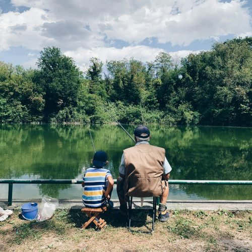 Grandfather and nephew fishing in the lake