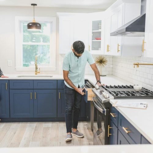 A man inspecting the kitchen drawer